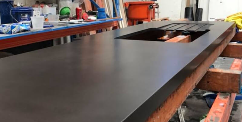 A black concrete kitchen sink being prepared for a Perth home