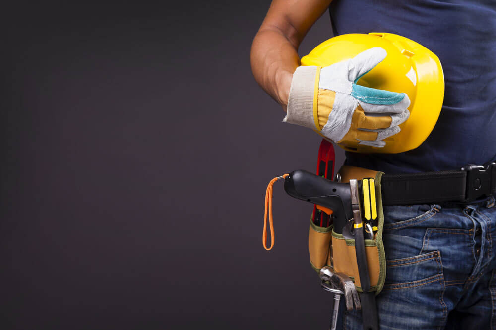 An image of a worker with a tool belt