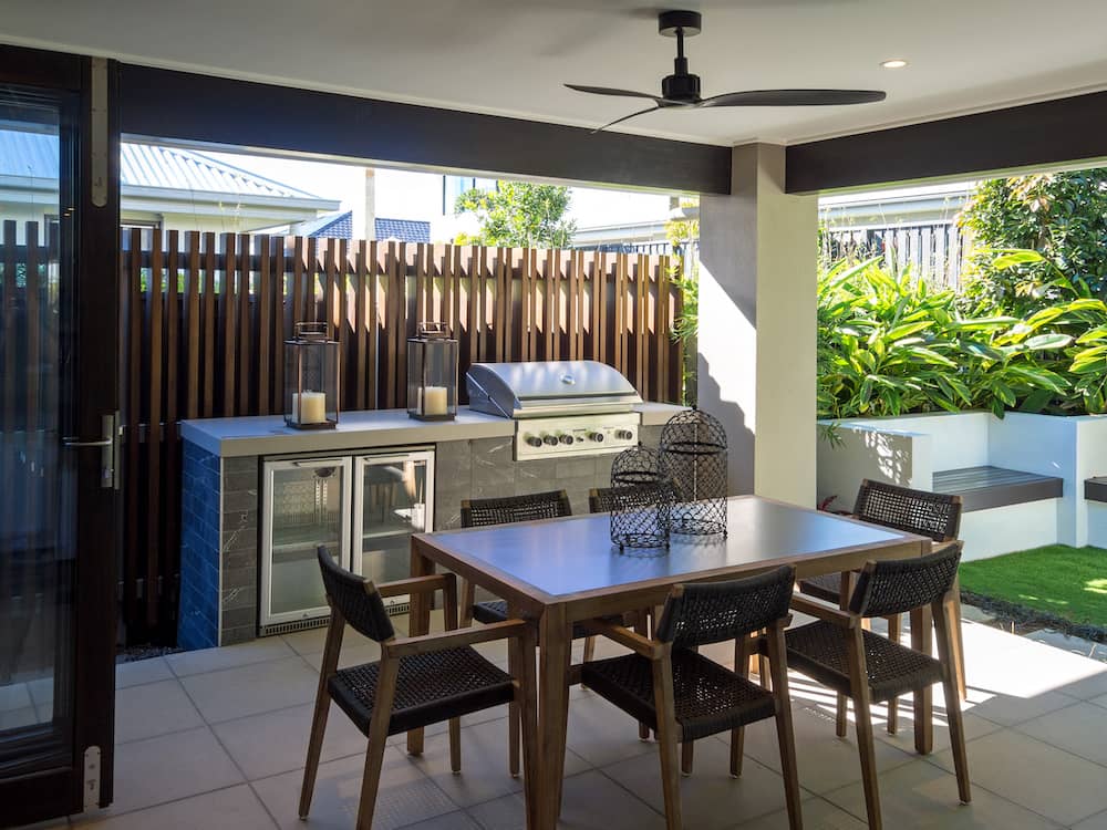 A small outdoor kitchen area with extra concrete bench seating in the background