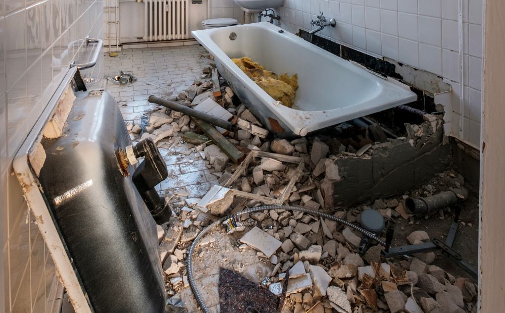Bathroom demolition, bathtub and sink removal.