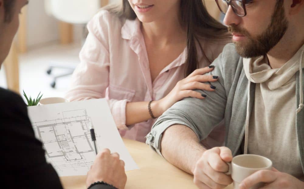 Couple consulting an architect for home renovation.