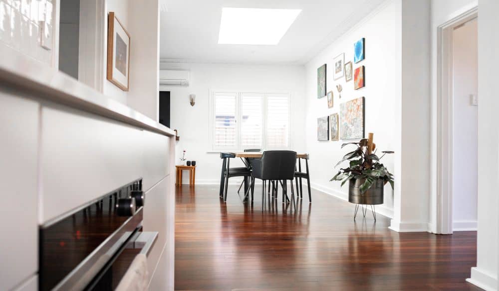 Living room with white walls and wooden flooring.